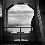Dec. 22, 1936 of a man looking at the Hudson River from the New York tower of the George Washington Bridge 